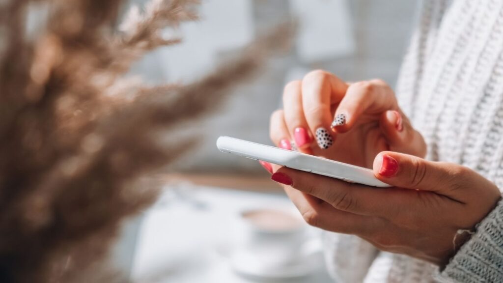 Person holding a mobile phone in their hands